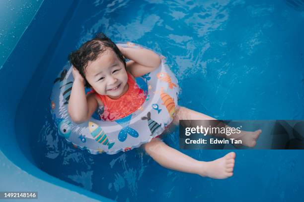 asian chinese baby girl enjoying me time in inflatable swimming pool - cute little asian girls 個照片及圖片檔