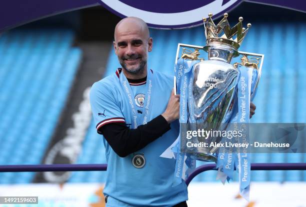 Pep Guardiola the manager of Manchester City lifts the Premier League Trophy after the Premier League match between Manchester City and Chelsea FC at...