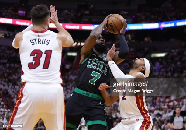 Jaylen Brown of the Boston Celtics drives to the basket against Gabe Vincent and Max Strus of the Miami Heat during the first quarter in game three...