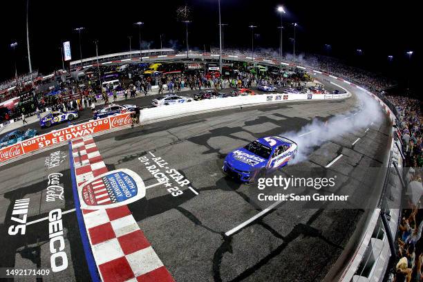 Kyle Larson, driver of the HendrickCars.com Chevrolet, celebrates with a burnout after winning the NASCAR Cup Series All-Star Race at North...