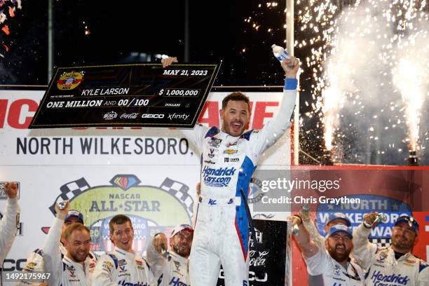 Kyle Larson, driver of the HendrickCars.com Chevrolet, celebrates with the one million dollar check in victory lane after winning the NASCAR Cup...