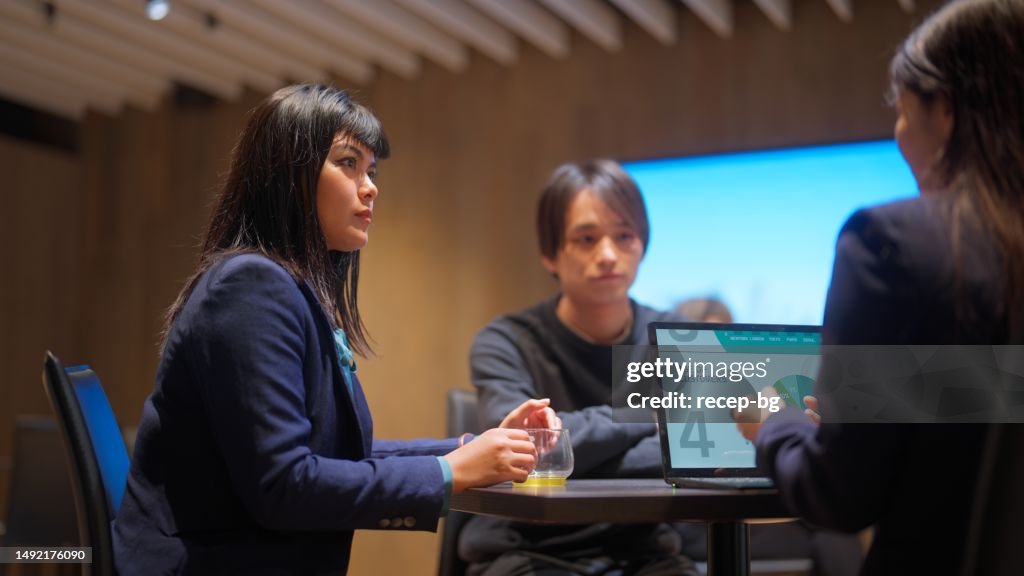 Business people having business meeting and discussion and consulting while having drinks in office
