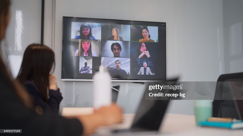 Group of business people joining online business conference meeting in office
