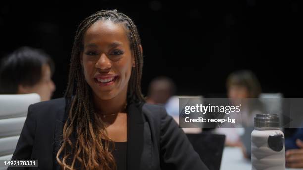 portrait of stylish beautiful businesswoman in board room in office - braiding hair stock pictures, royalty-free photos & images