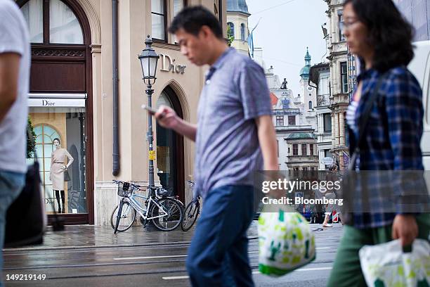 Pedestrians pass a Christian Dior SA store on Maximilianstrasse in Munich, Germany, on Wednesday, July 25, 2012. Spending at German department...