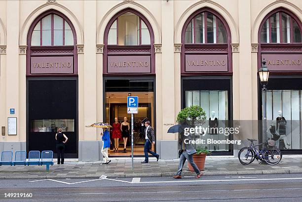 Pedestrians walk past a Valentino fashion store, owned by Valentino Fashion Group SA, on Maximilianstrasse in Munich, Germany, on Wednesday, July 25,...