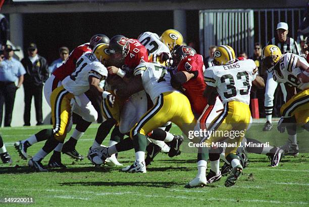 Fullback Mike Alstott of the Tampa Bay Buccaneers charges for a few extra yards in a NFL game against the Green Bay Packers at Tampa Stadium on...