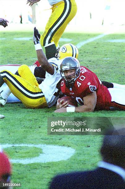 Fullback Mike Alstott of the Tampa Bay Buccaneers gets tackled by a member of the Green Bay Packers in a NFL game against the at Tampa Stadium on...