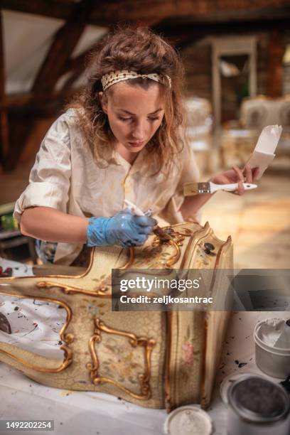 a woman restorer of old antique furniture - bureau stock pictures, royalty-free photos & images