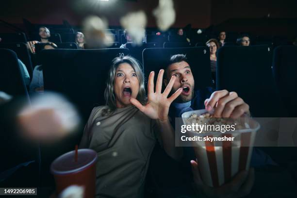 watching a horror movie in cinema! - medo imagens e fotografias de stock