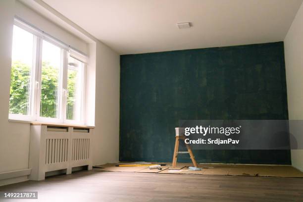 new apartment with a dark blue painted wall - wring out stock pictures, royalty-free photos & images