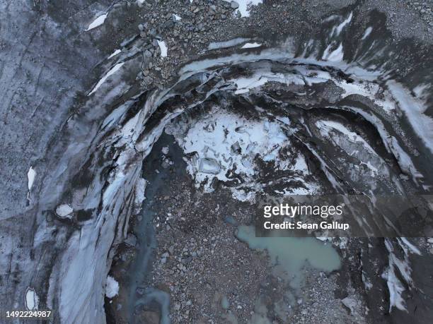 In this aerial view a collapsed portion of the receding Morteratsch glacier lies near its snout on May 21, 2023 near Pontresina, Switzerland. On June...