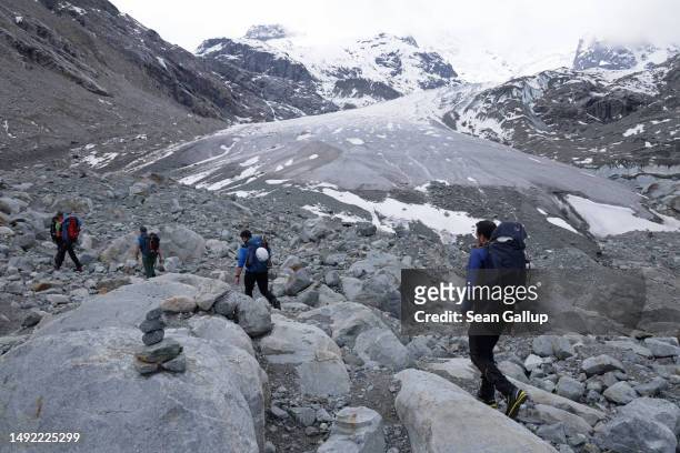 Alpinists arrive to walk across the receding Morteratsch glacier on May 21, 2023 near Pontresina, Switzerland. On June 18 Swiss voters will go to the...
