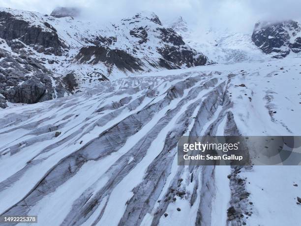 In this aerial view ice fissures streak the receding Morteratsch glacier on May 21, 2023 near Pontresina, Switzerland. On June 18 Swiss voters will...