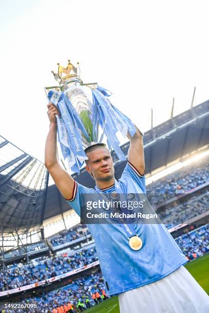 Erling Haaland of Manchester City poses with the Premier League trophy after the Premier League match between Manchester City and Chelsea FC at...