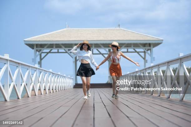 friends travel - feet run in ocean stock pictures, royalty-free photos & images