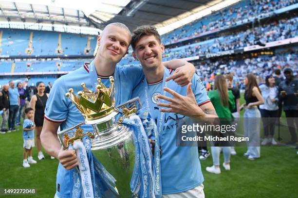 Erling Haaland and John Stones of Manchester city pose with the trophy after the Premier League match between Manchester City and Chelsea FC at...