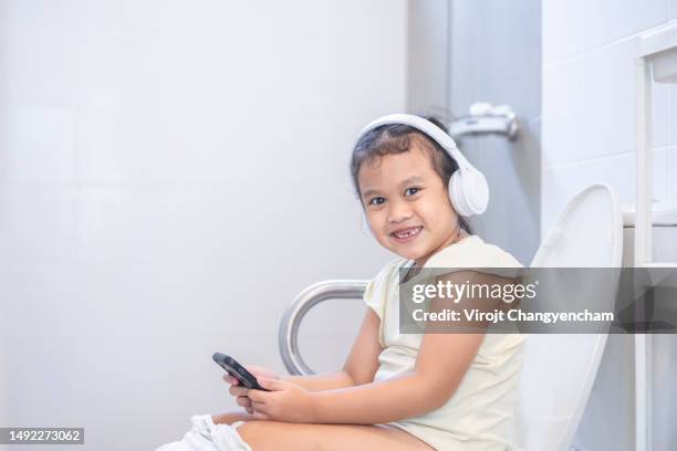 little girl use toilet at home - trousers down stock pictures, royalty-free photos & images