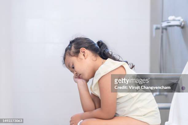 little girl use toilet at home - trousers down stock pictures, royalty-free photos & images