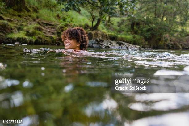 enjoying the calm waters - woman and river uk stock pictures, royalty-free photos & images