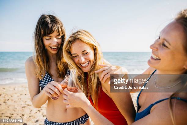 three women hanging out at the beach - mid twenties fun foto e immagini stock