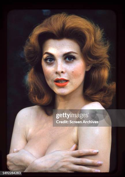 Tina Louise poses topless with her hands covering chest for a publicity portrait, circa 1958.