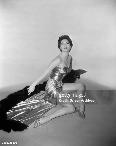 Ava Gardner poses for a publicity portrait wearing exotic gown 1950's.