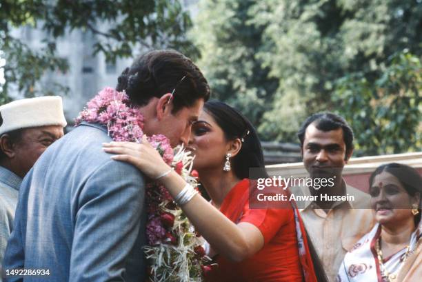 Prince Charles, Prince of Wales receives a garland and a kiss from Indian actress Padmini Kolhapure at the Rajkamal Kalamandir film studio on...