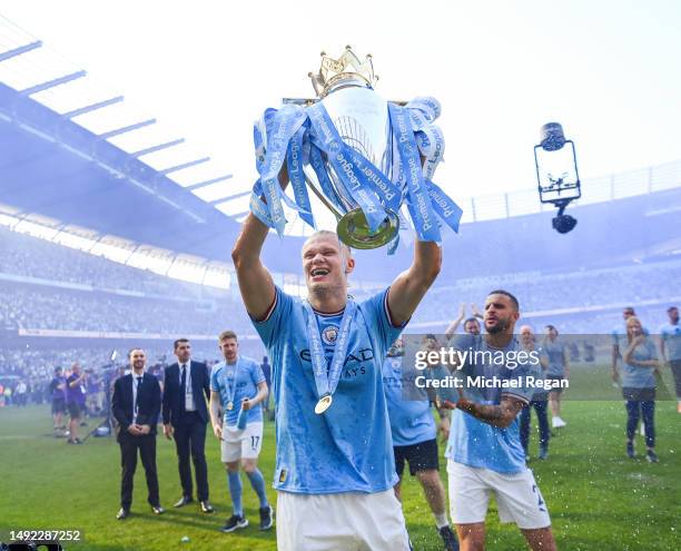 Erling Haaland of Manchester City poses with the Premier League trophy after the Premier League match between Manchester City and Chelsea FC at...