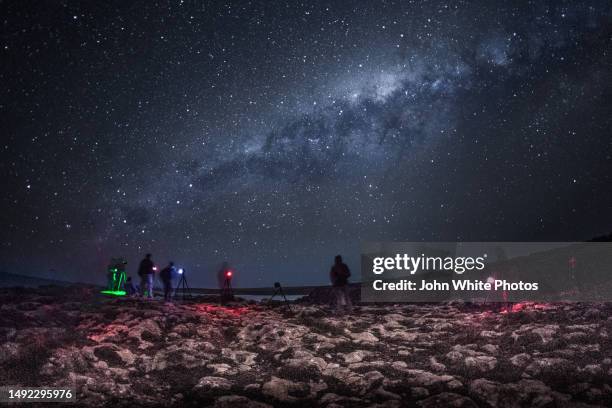 group of photographer taking long exposures oh the night sky and the milky way. the mine. sleaford bay. eyre peninsula. south australia. - milky way stock pictures, royalty-free photos & images