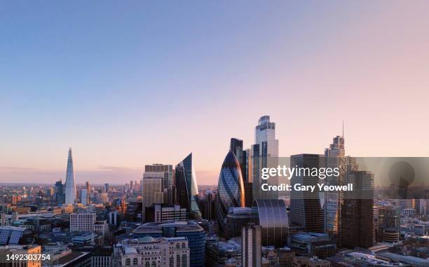 elevated view over city of london skyline at sunset - london stock-fotos und bilder