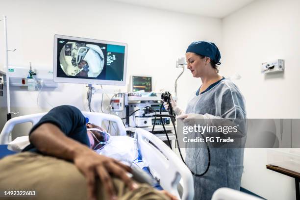 doctor doing an endoscopy in the patient in the hospital room - endoskop bildbanksfoton och bilder