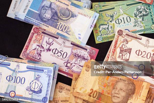 South African Rands and Orania Ora currency bills displayed after sales of pancakes at a Rugby tournament benefiting Gereformeerde Kerk Oranjerivier,...