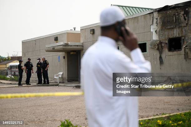 Police and community members gather outside the burned-out Tawhid Islamic Center Wednesday, May 17, 2023 in St. Paul, Minn.. The Council on American...