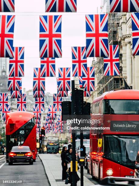 british flags strung across regent street in central london, uk - london bus stock pictures, royalty-free photos & images