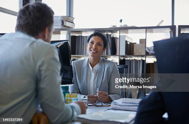 confident businesswoman smiling at colleague - black tie stock pictures, royalty-free photos & images