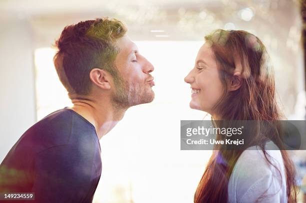 young couple about to kiss - キス ストックフォトと画像