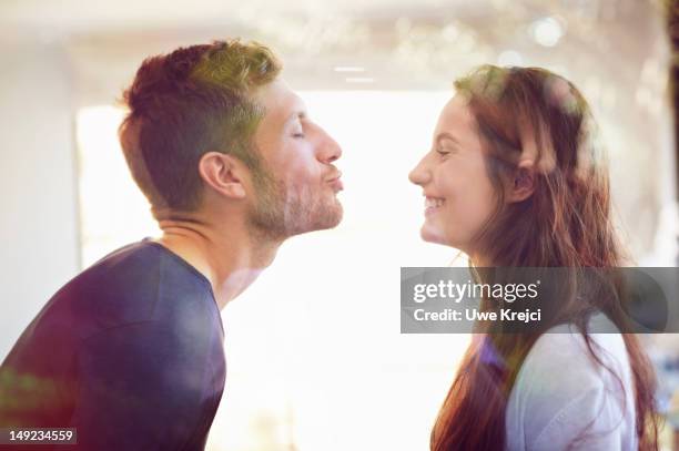 young couple about to kiss - verliefd worden stockfoto's en -beelden