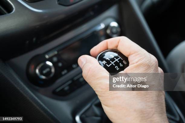 a person changes gear while driving in a car. - gear shift stockfoto's en -beelden