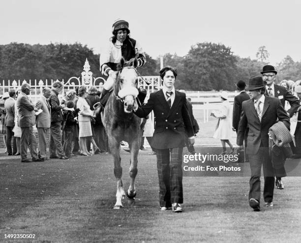 Jockey Brooke Sanders is led into the winners unsaddling enclosure after winning the Koh-I-Noor Diamond Stakes horse race during the Ascot race...