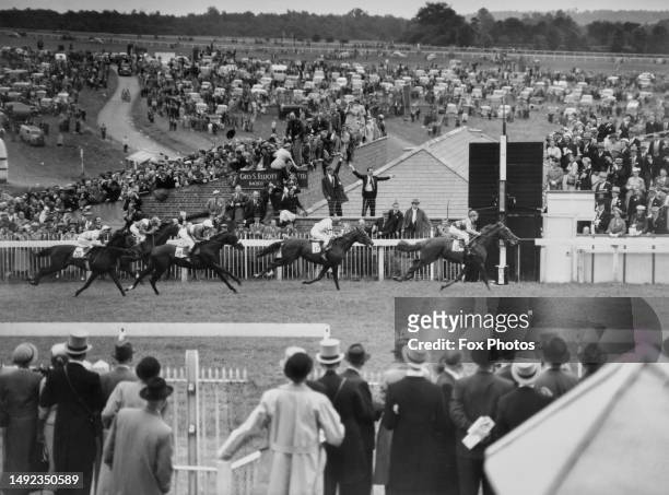 The crowd of spectators look on as Crepello ridden by jockey Lester Piggott wins the Epsom Derby horse race from Tommy Burns on Ballymoss on 5th June...