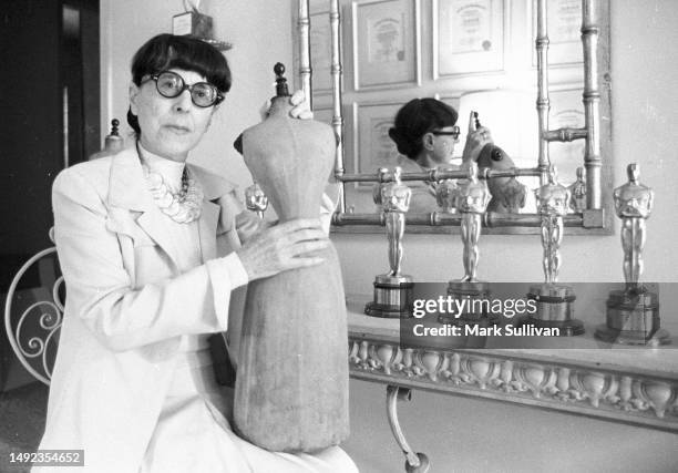 Costume Designer Edith Head poses in her Universal Studios bungalow with some of her eight Academy Awards in Universal City, CA 1975.