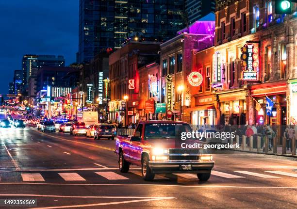 chevy truck among traffic in nashville - lower broadway stock pictures, royalty-free photos & images