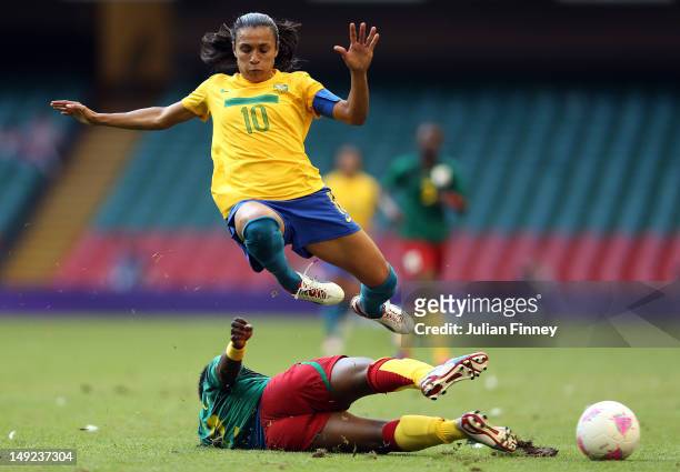 Marta of Brazil is tackled by Christine Manie of Cameroon during the Women's Football first round Group E Match of the London 2012 Olympic Games...