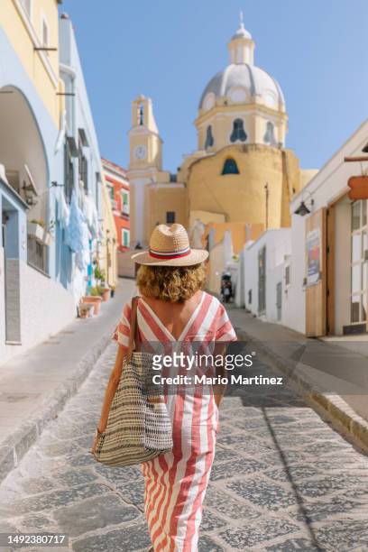 unrecognizable woman walking on paved street with church - naples italy church stock pictures, royalty-free photos & images