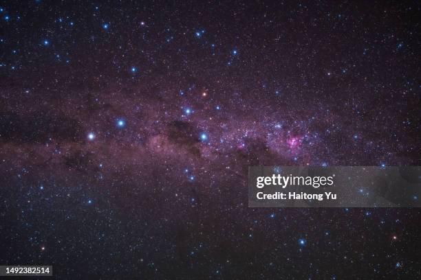 shining milky way with red nebula - southern cross stars stock pictures, royalty-free photos & images
