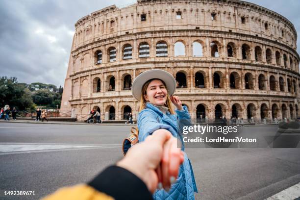 happy woman leading her boyfriend to the colosseum, rome - rome empire stock pictures, royalty-free photos & images