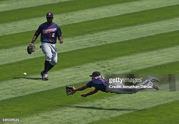 Ben Revere of the Minnesota Twins dives for a ball hit by Kevin Youkilis of the Chicago White Sox in front of teammate Denard Span at U.S. Cellular...