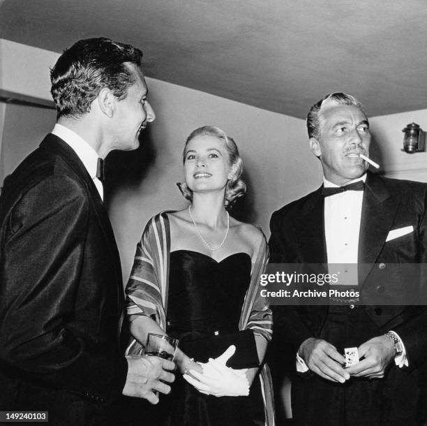 From left to right, fashion designer Oleg Cassini , American actress Grace Kelly and actor Cesar Romero , circa 1955.