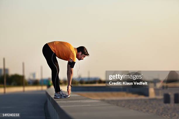 man stretching on the beach - stretching stock pictures, royalty-free photos & images